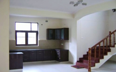 Interior view showing a kitchen counter, cabinets, and a staircase
